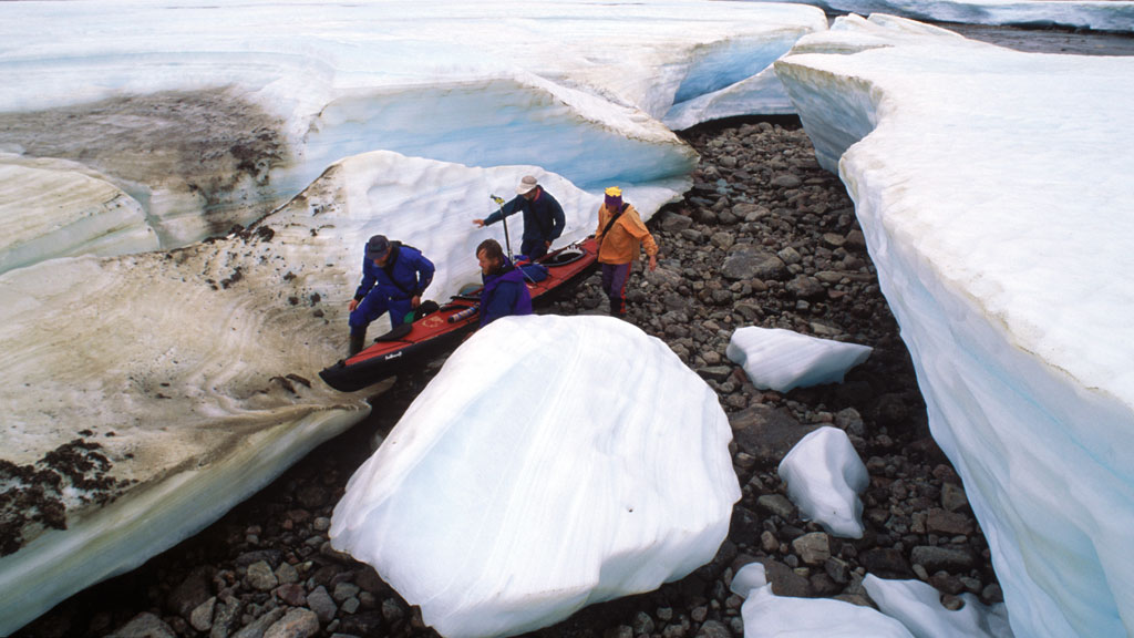  Portaging the Feathercraft through the remnants of a massive snow drift 